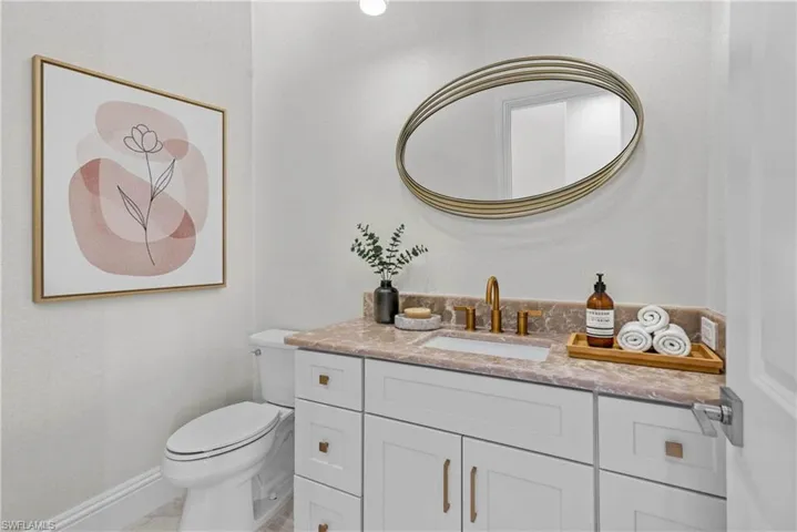 Half bathroom featuring baseboards and vanity