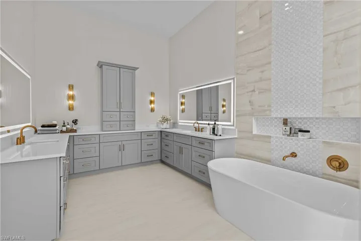 Full bath with a freestanding tub and two vanities