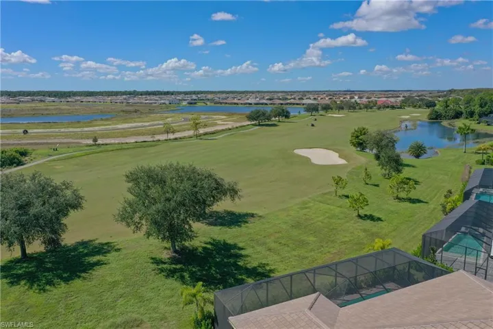 Drone / aerial view of a large body of water and a golf course