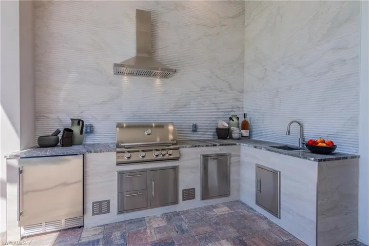 View of patio / terrace with exterior kitchen and a sink