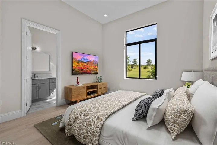 Bedroom featuring light wood-type flooring, recessed lighting, and ensuite bath