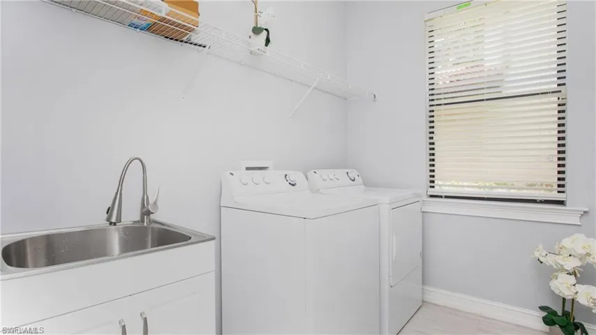 Washroom with washer and dryer, healthy amount of natural light, and cabinet space
