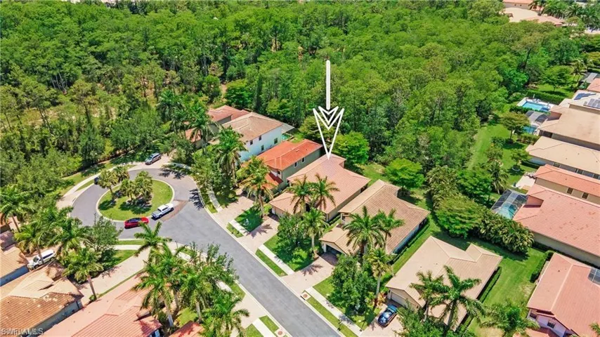 Aerial perspective of suburban area featuring a forest