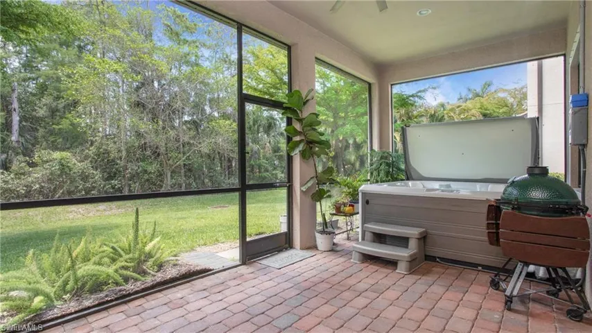 Sunroom / solarium featuring a hot tub