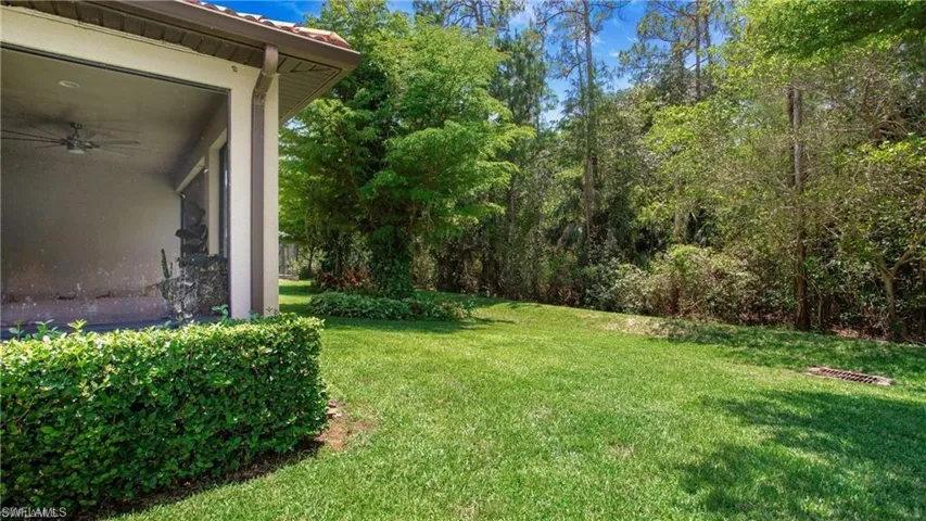 View of green lawn featuring a ceiling fan