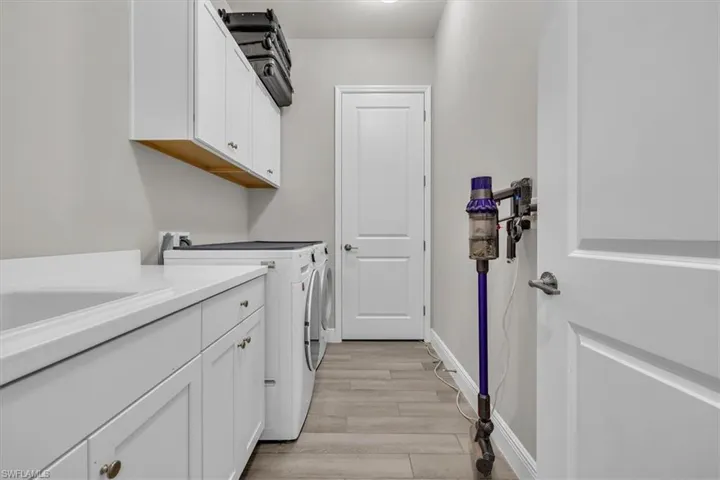 Laundry in back hallway with large walk in closet