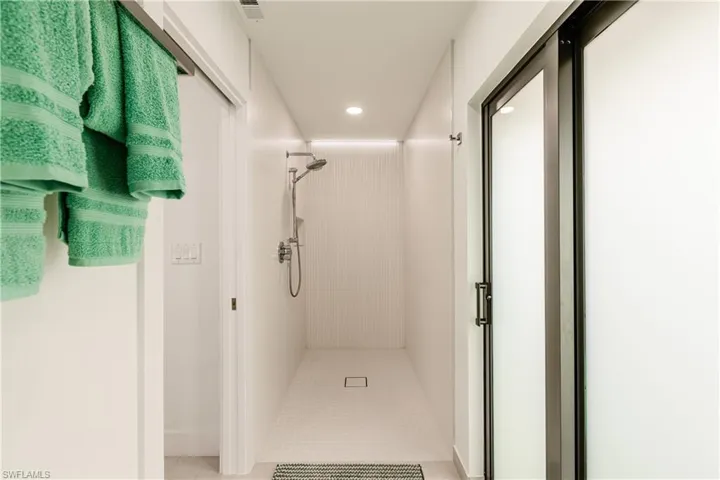 Bathroom featuring a shower stall, recessed lighting, and light tile patterned floors
