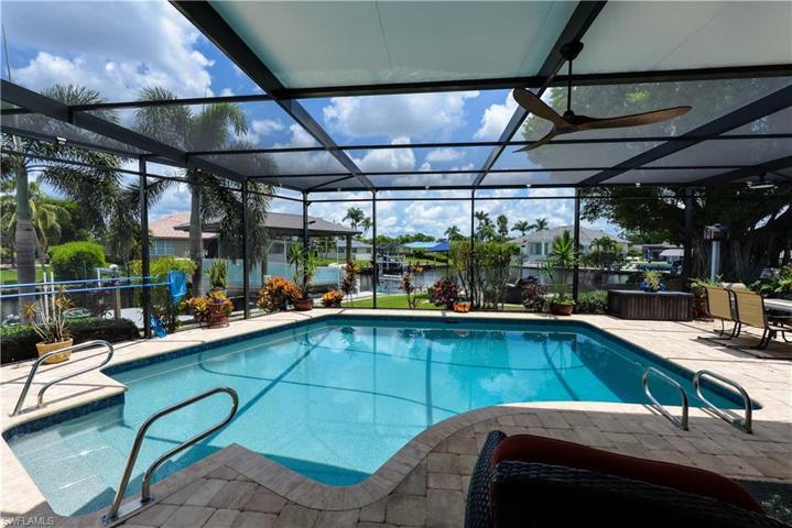 VIEW OF THE LARGE POOL FROM THE SIDE OF THE YARD