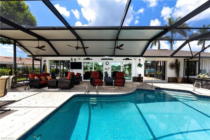 VIEW OF THE LARGE POOL FROM THE REAR OF THE HOME