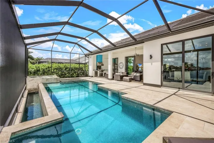 View of pool featuring ceiling fan, a sunroom, a patio area, a lanai, and an outdoor hangout area