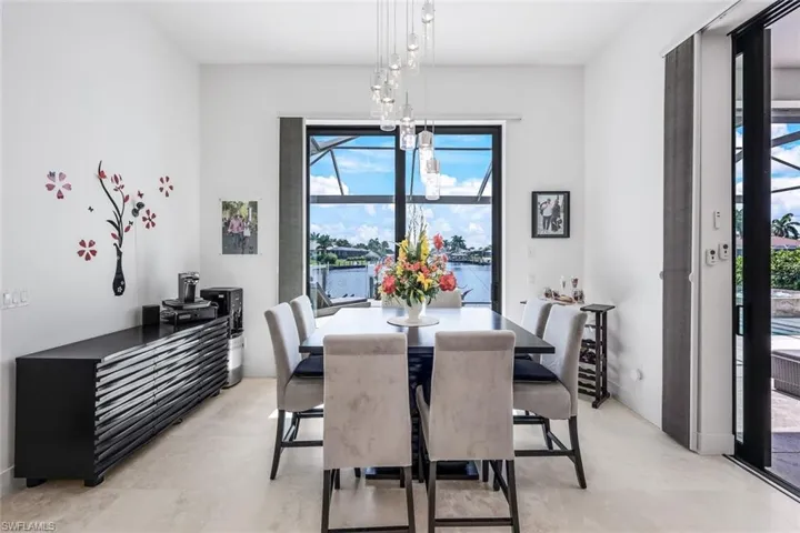 Dining space with a water view, plenty of natural light, and a chandelier