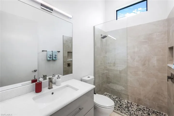 Full bathroom with vanity and walk in shower