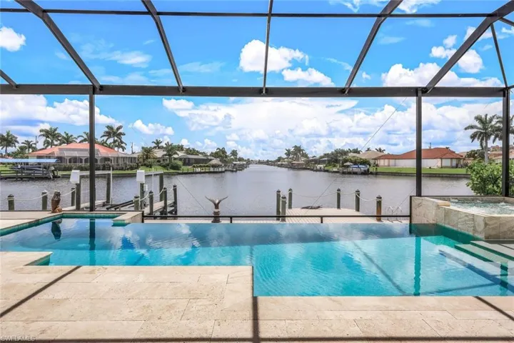 View of pool featuring a water view, a boat dock, and a lanai