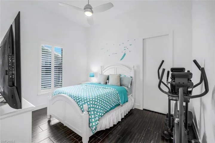 Bedroom featuring wood tiled floors and a ceiling fan