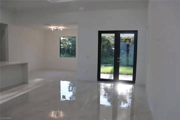 Empty room featuring french doors