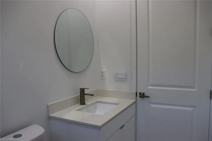 Bathroom featuring vanity and toilet