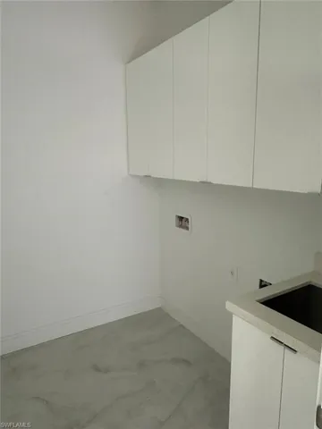 Washroom with cabinets and hookup for a washing machine