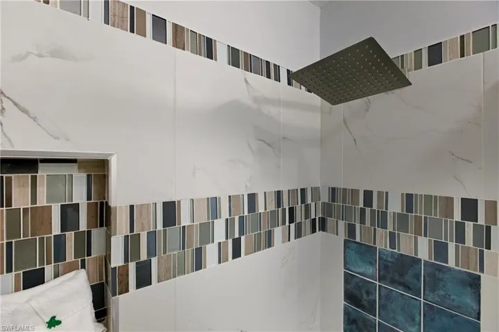 Bathroom view of a tile shower