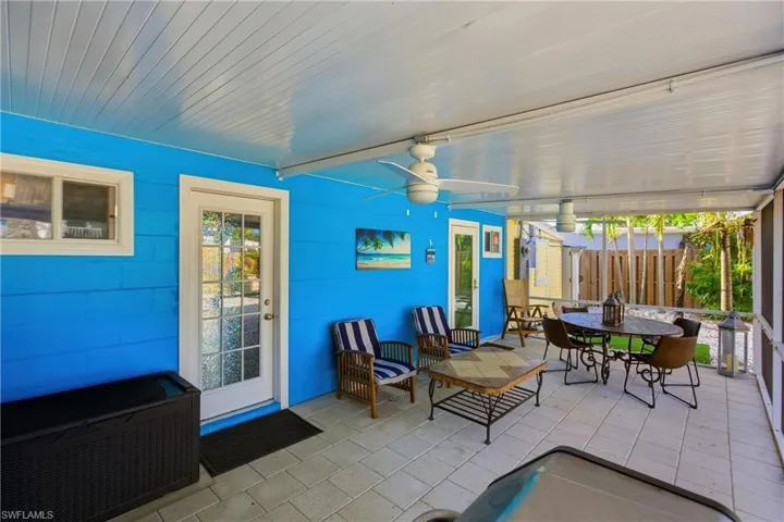 View of patio with a sunroom, ceiling fan, and outdoor dining area