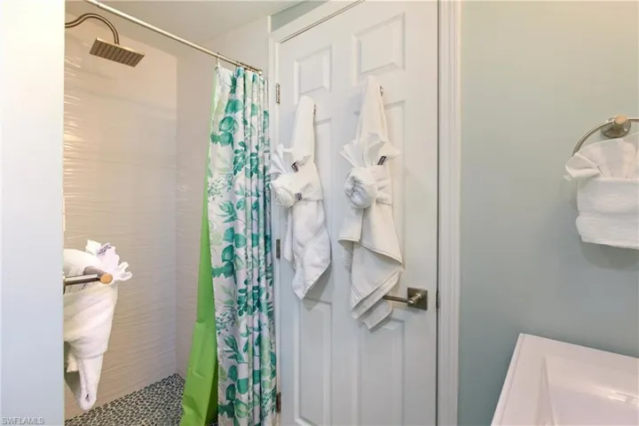 Full bath featuring a stall shower and a sink