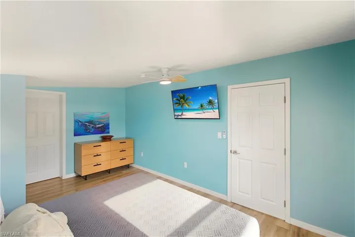 Bedroom with wood finished floors and a ceiling fan