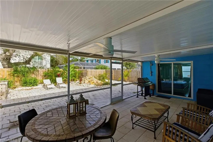 Fenced backyard featuring a ceiling fan, a patio, and a grill