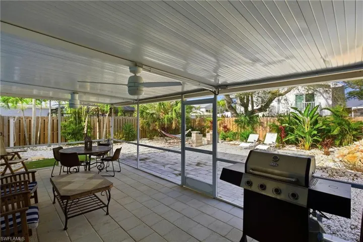 Sunroom / solarium with a patio and outdoor dining area