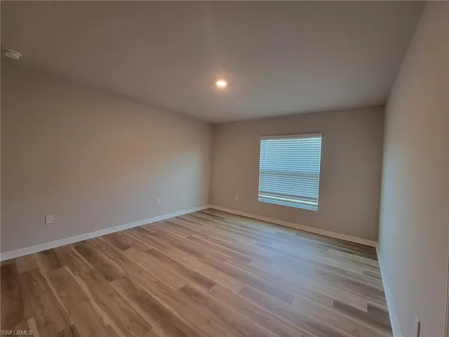 Unfurnished room with hardwood / wood-style floors