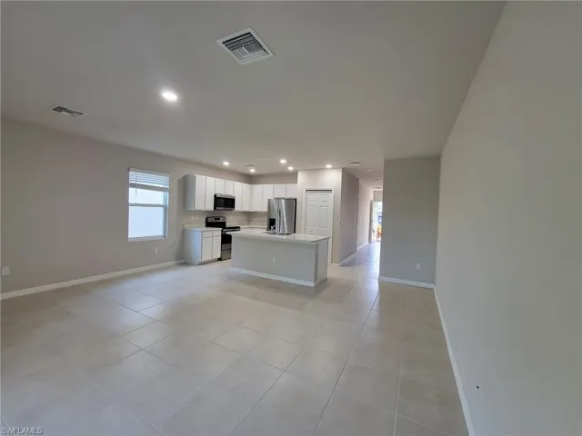 Unfurnished living room with light tile patterned flooring