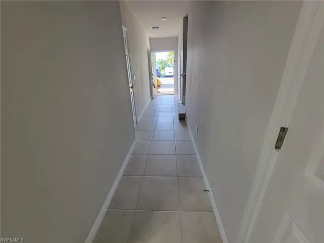 Hallway with light tile patterned floors