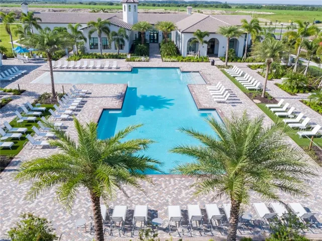 Community pool featuring a patio and a pergola