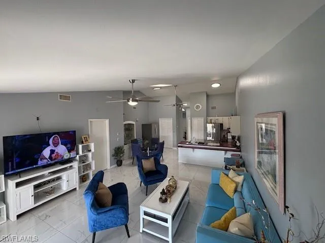 Living room with arched walkways and ceiling fan