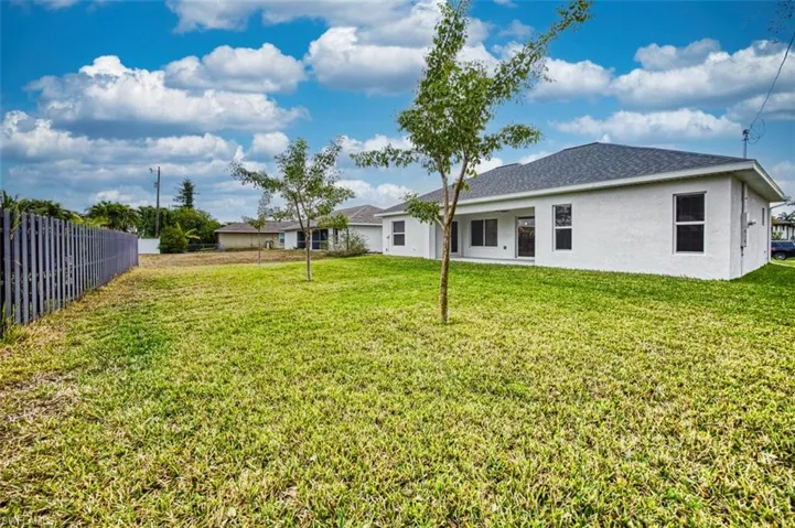 Rear view of house featuring a patio area and stucco siding