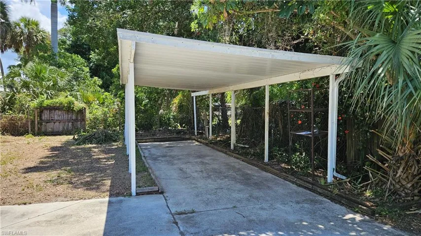 View of patio / terrace featuring driveway and a carport