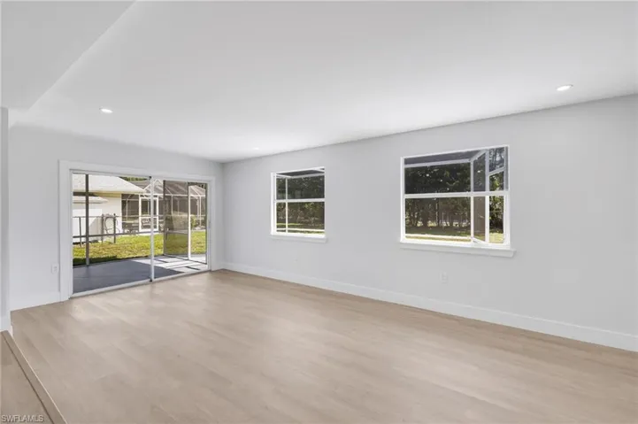 Empty room with light wood-style floors, recessed lighting, and baseboards