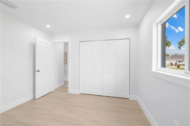 Unfurnished bedroom featuring light wood-type flooring, baseboards, visible vents, and recessed lighting