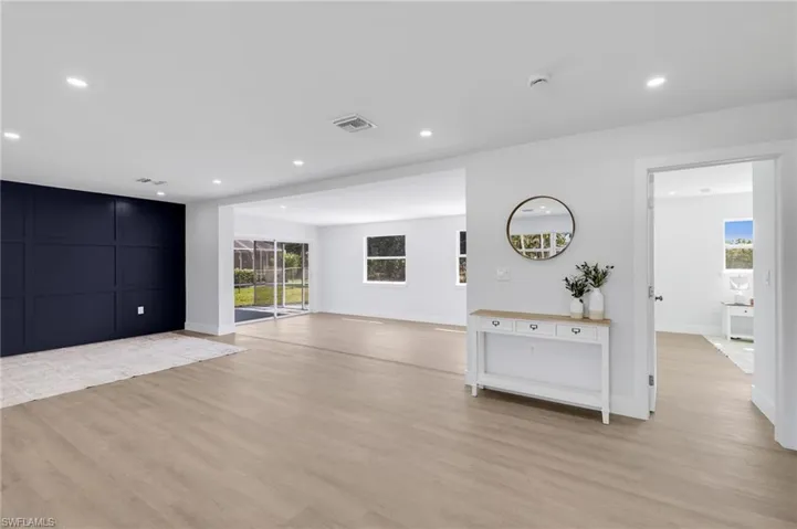 Unfurnished living room featuring recessed lighting, baseboards, visible vents, and light wood finished floors