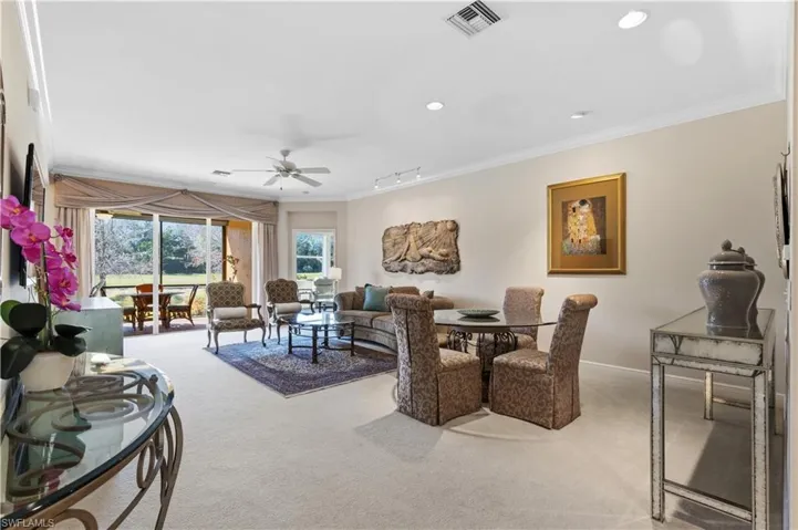 Recessed lighting, crown molding, and a ceiling fan enhance the living space