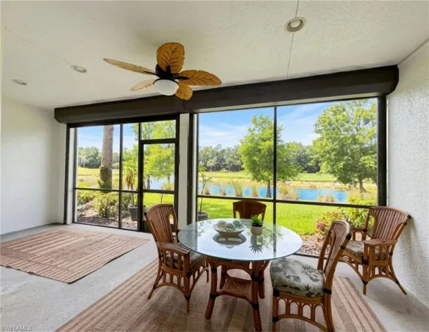 Screened lanai featuring a tropical-style ceiling fan and recessed lighting