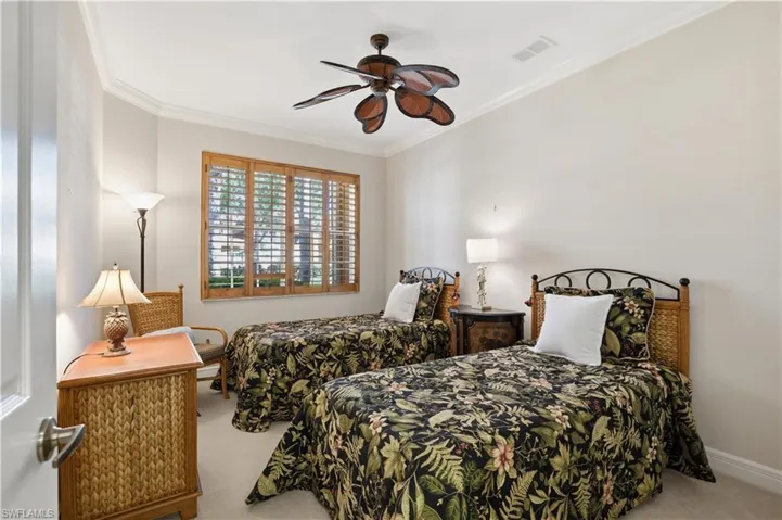 Crown molding accents the ceiling, complemented by a ceiling fan