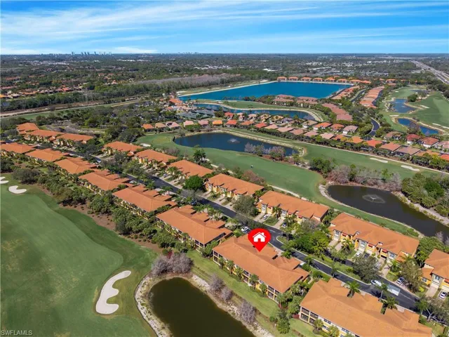 Aerial perspective of a multi-building residential complex, featuring tile roofs and multiple water features