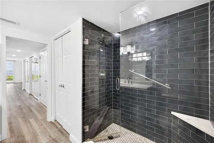 Primary bathroom featuring a stall shower and light wood-style flooring