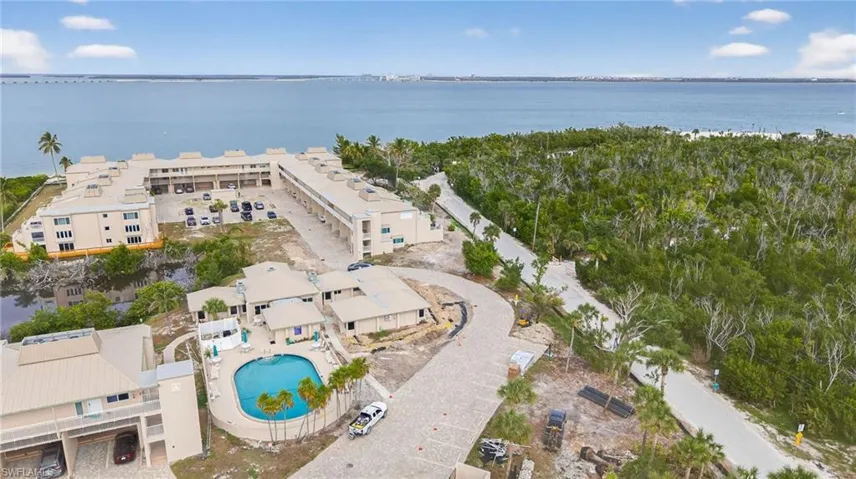 Aerial view of a pool area and a nearby body of water