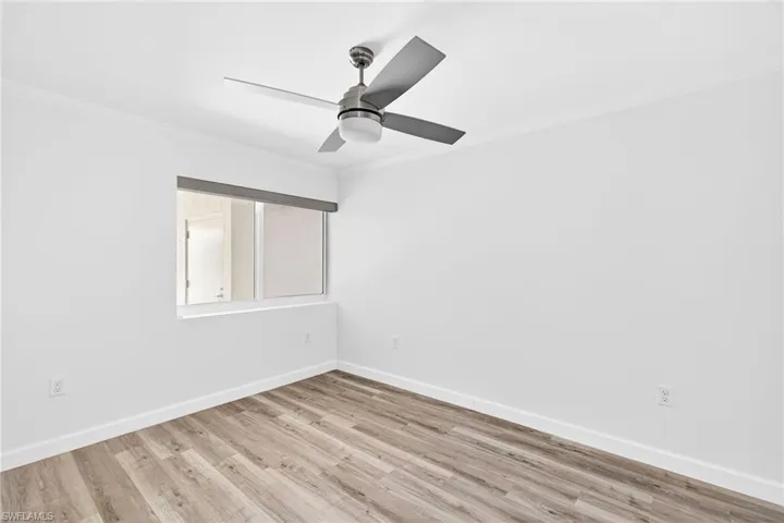 Bedroom featuring ornamental molding and light wood-style flooring