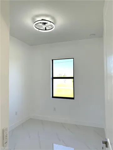 Unfurnished room with light marble finish flooring