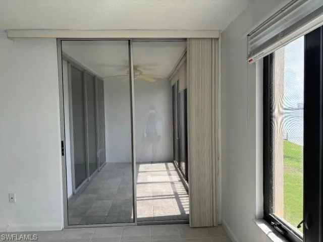 Empty room featuring a ceiling fan and baseboards
