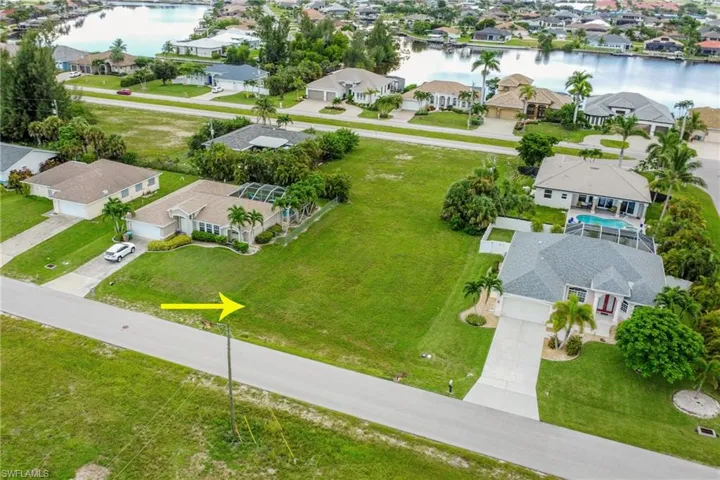 Aerial perspective of suburban area with a nearby body of water