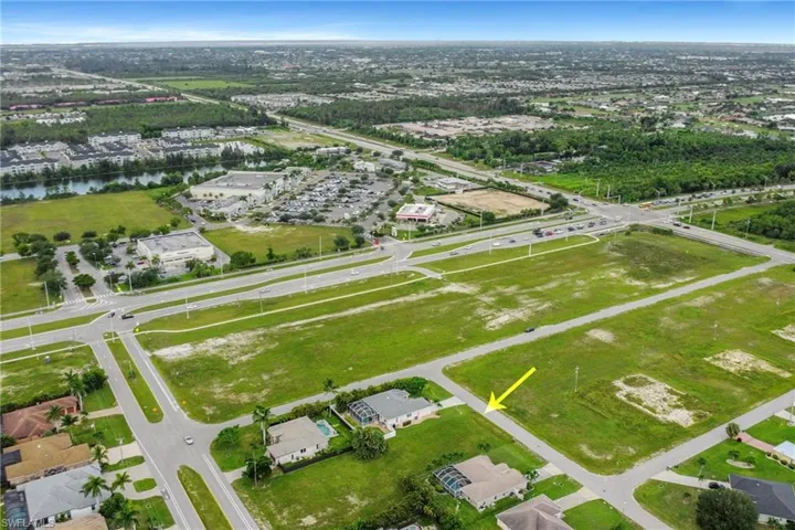 Aerial view of property's location featuring a large body of water and nearby suburban area