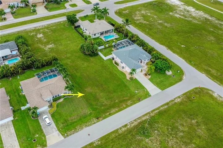 Aerial view of residential area featuring a pool