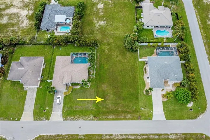 Aerial perspective of suburban area featuring a pool